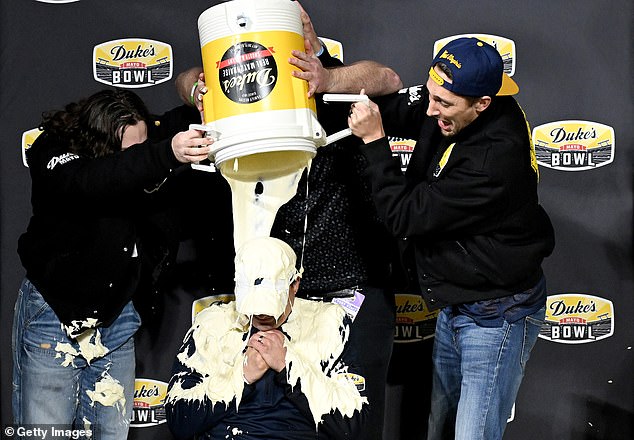 West Virginia head coach Neil Brown was dosed with mayonnaise after winning the Mayo Bowl