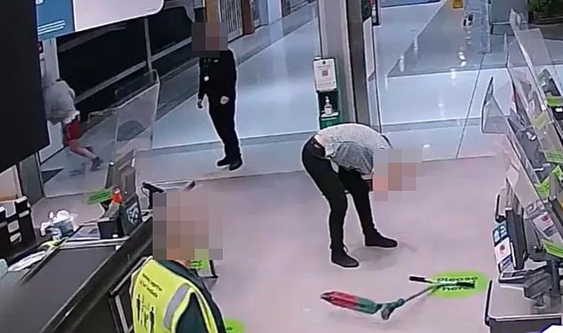 A young Woolworths worker doubles over in pain after being hit by a thrown metal scooter (pictured on the floor)