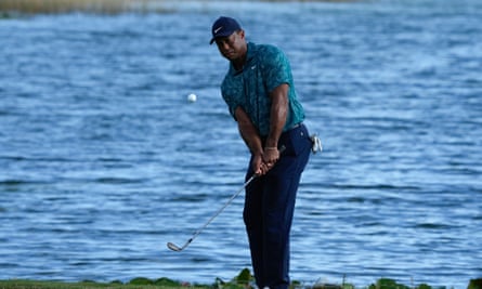 Tiger Woods chips his ball onto the green at the 18th hole of his second round of the Hero World Challenge. 