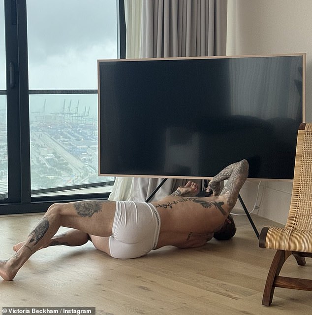 Victoria Beckham, 49, shared a VERY racy photo of husband David, 48, in his Calvin Klein underwear on Instagram on Friday as he fixed the TV at their New York hotel