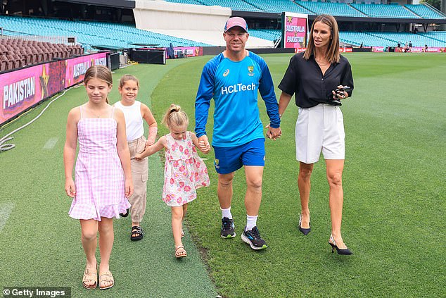 Warner arrives at his media conference with wife Candice and children Ivy Mae, Indy Rae and Isla Rose