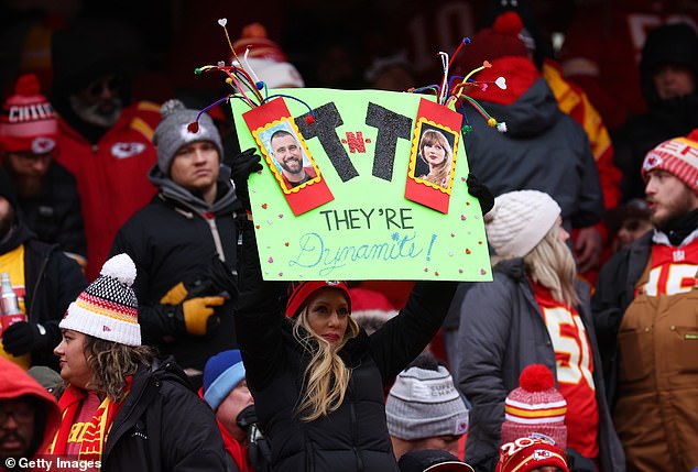 This Chiefs fan held a poster comparing Swift and Kelce's romance to TNT: 