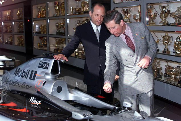 Dennis shows the future King Charles in the McLaren trophy room at their factory in 1999