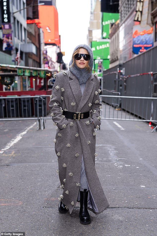 She dressed warmly from the cold winter weather and wore a gray teddy snood over her head