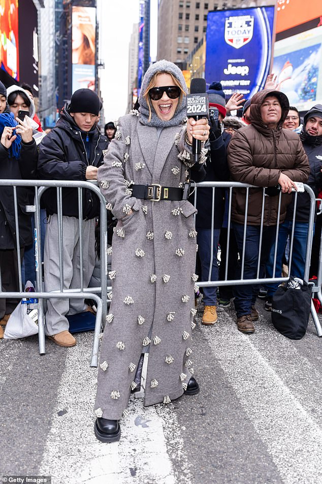 Rita was seen holding a microphone as she chatted with the crowd outside in the Big Apple ahead of her television appearance on New Year's Eve