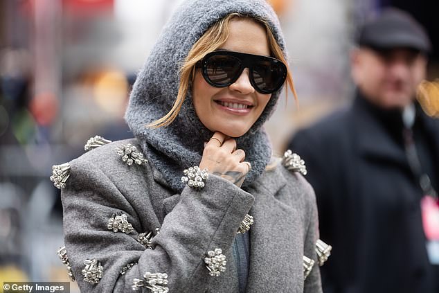 Pop star Rita wore dark sunglasses and smiled as she posed in Manhattan this weekend