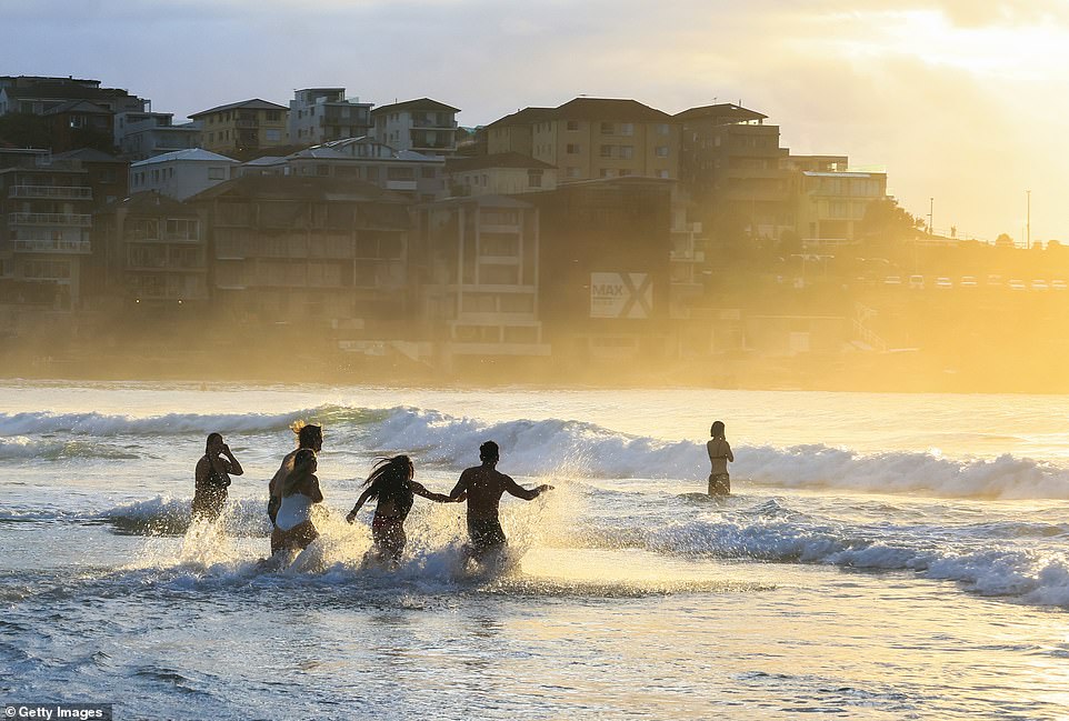 Eager beachgoers also stripped down to their underwear and dashed across the famous golden sand, before bracing themselves in the icy water