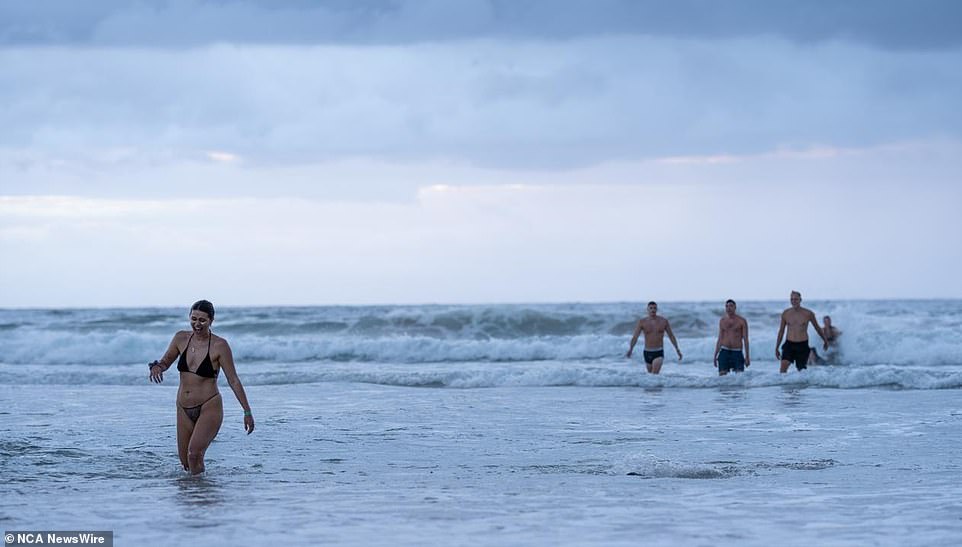 Some took to the water even though the temperature remained around 18 degrees for most of the morning