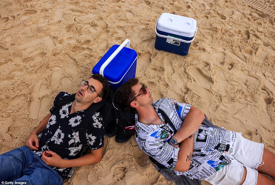 A few revelers rest on the beach after a night of partying in Bondi