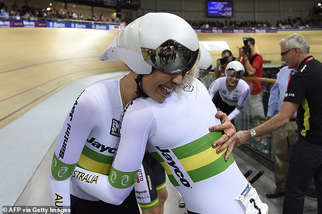 Melissa Hoskins (left) hugs Annette Edmondson as they celebrate after winning the women's team pursuit final at the 2015 UCI Track World Championships