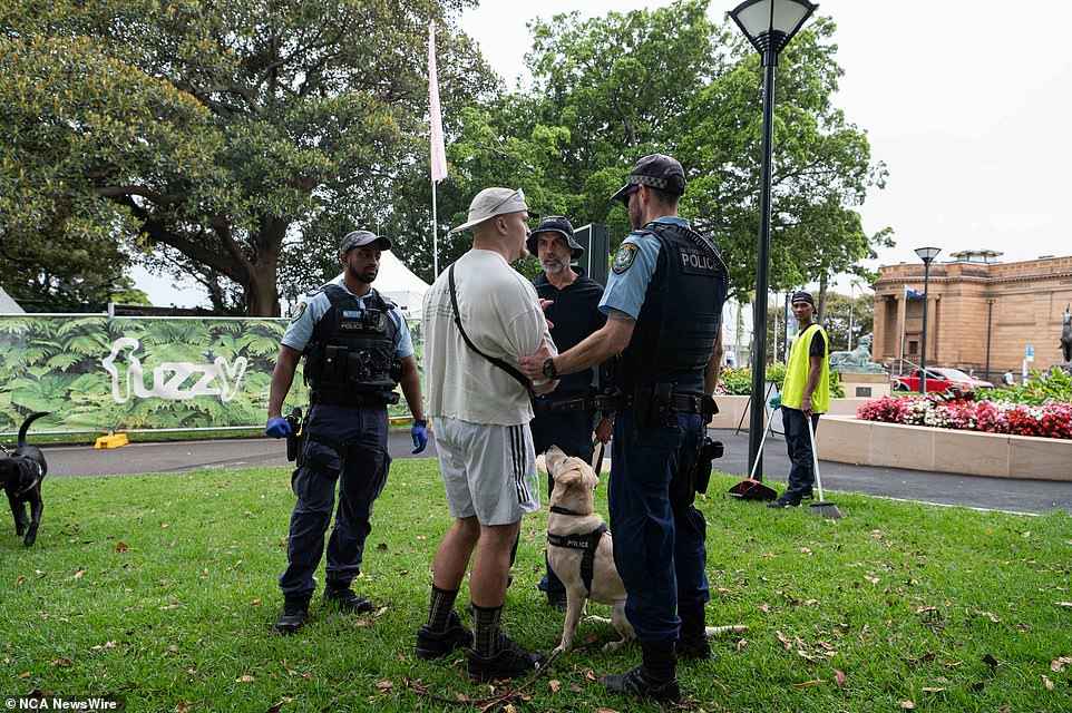A man was seen speaking to three police officers with a sniffer dog outside the event
