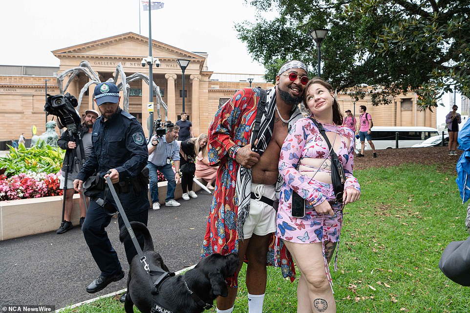 A couple in brightly colored, patterned ensembles posed as sniffer dogs and passed by