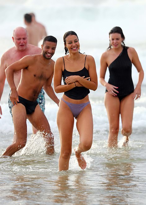 The partygoers were all smiles as they took an ice-cold dip at Bondi Beach