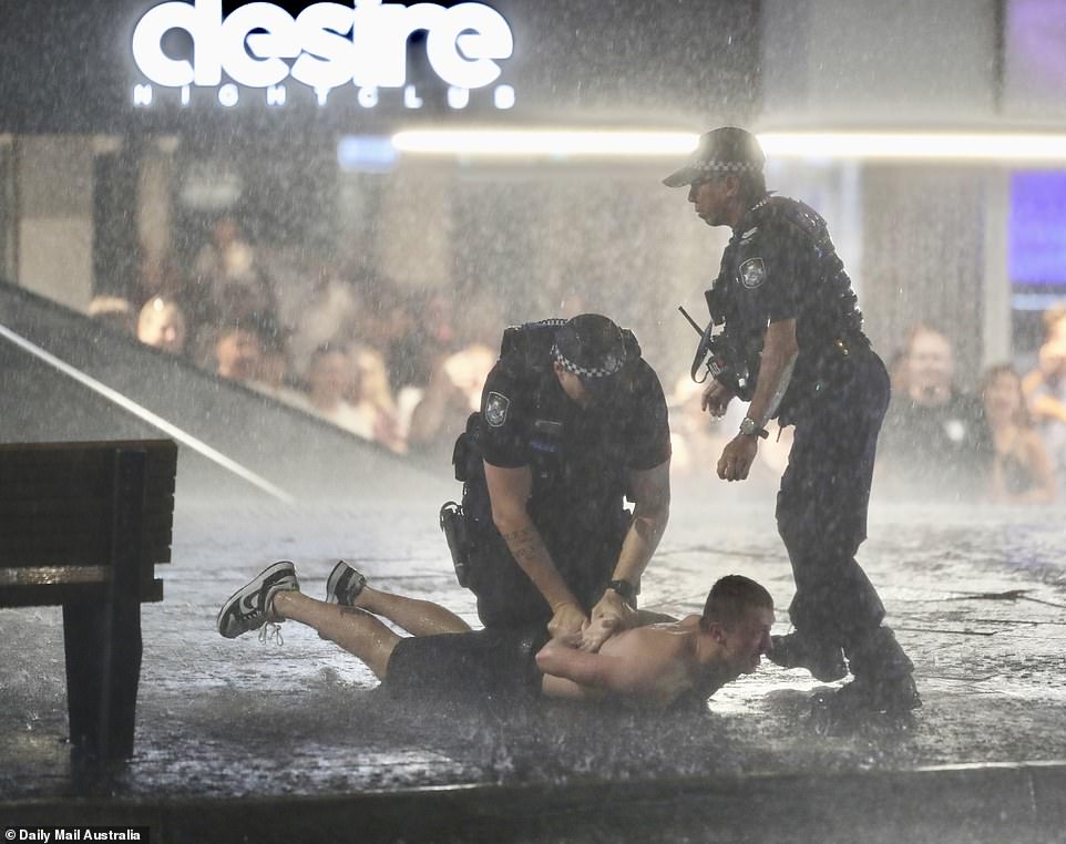 Police were seen restraining a shirtless man outside a Gold Coast nightclub