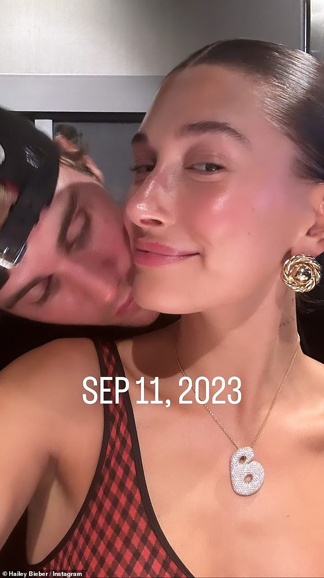 Justin appeared to place a kiss on his wife's neck in a selfie shot on September 11