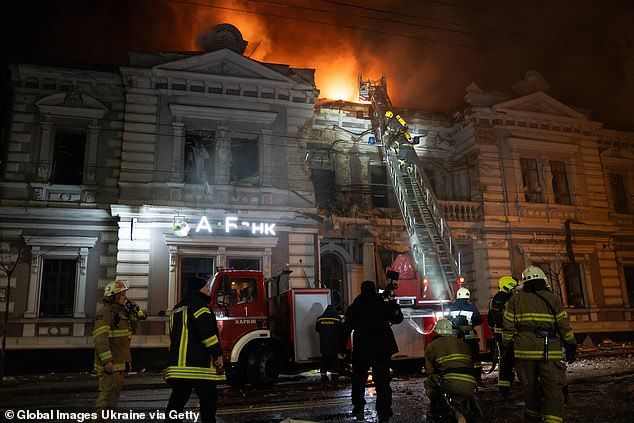 Rescue workers respond to the scene of a rocket attack on a bank building on December 31, 2023 in Kharkiv, Ukraine
