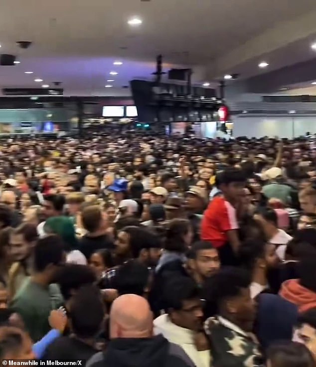 The platforms of Melbourne's Flinders Street Station were packed with thousands of people trying to catch the train home after New Year's Eve celebrations (pictured)