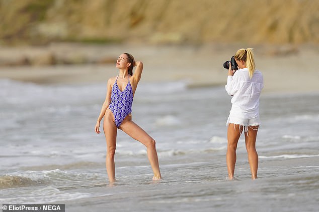 Kimberley was far from the only stunner on land, but her photographer also put on a stunning show in a white button-up shirt and shorts with a frayed hem.