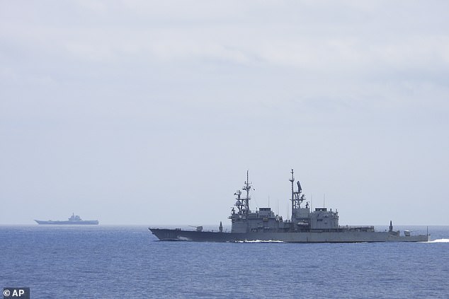 In this file photo released by Taiwan's Ministry of National Defense, the Taiwanese Navy ship Keelung, in the foreground, monitors a US-made Kidd Class destroyer, the Chinese aircraft carrier Shandong, in the background, near Taiwanese waters in September 2023