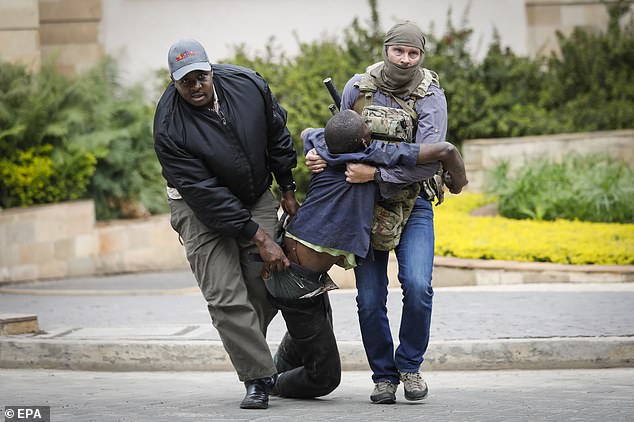 Craighead and a security officer escort an injured man who was attacked during the terror siege