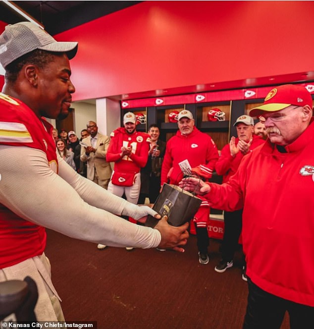 Chris Jones presents a gift to Reid on behalf of the players after the win over the Bengals