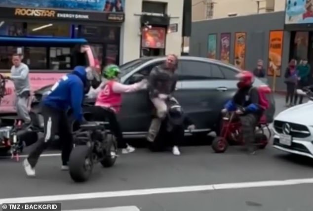 As he struggled with one rider, he was swarmed by others who attacked him