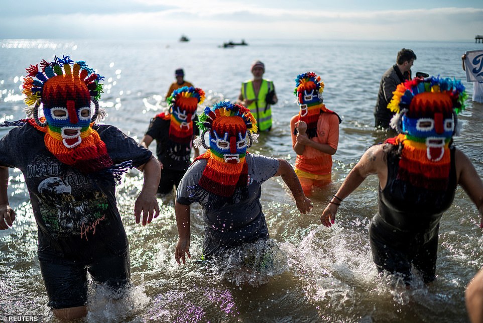 A group of swimmers celebrated the annual Coney Island swim on Monday wearing colorful knitted head masks