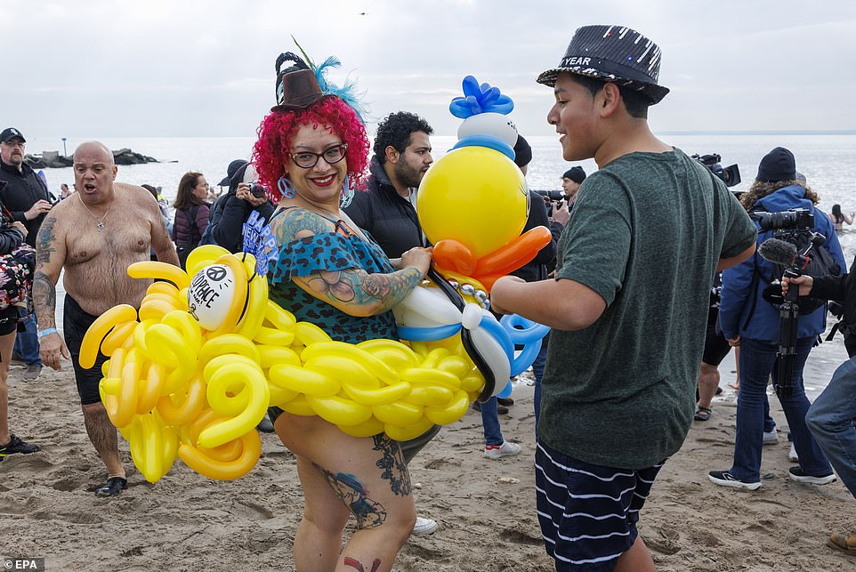 A woman wearing a rubber ducky float enjoyed herself at the annual event that draws thousands in Coney Island