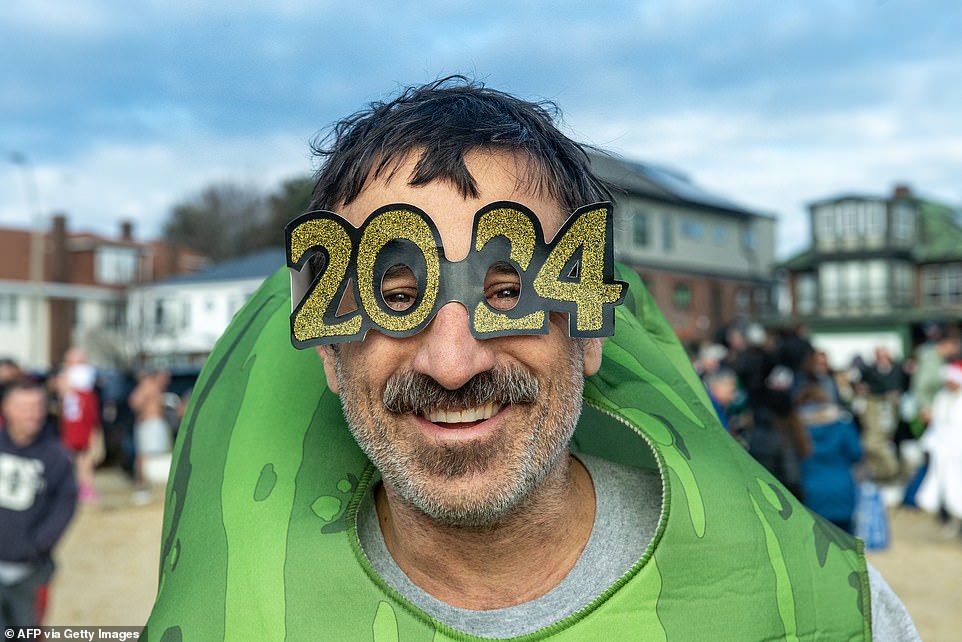 One swimmer wears glittery gold and black 2024 party goggles