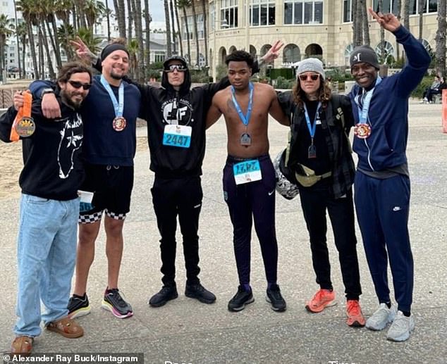 After finishing the 'low-key' race, Travis triumphantly posed on the beach with (from L-R) Ecuadorian MMA fighter Marlon Chito Vera, TikToker Carl Dawson, herbivore athlete Alexander Ray Buck and fitness trainer Don Brooks