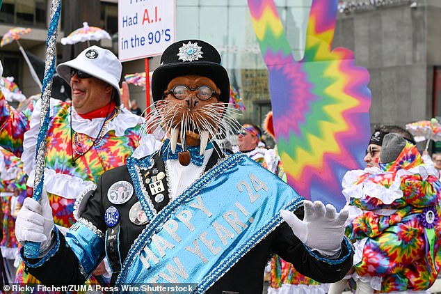 A parade goer is dressed as a ground hog