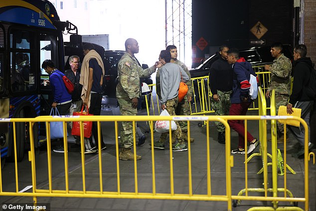 Migrants in New York City are seen being bused to a shelter after arriving from Texas