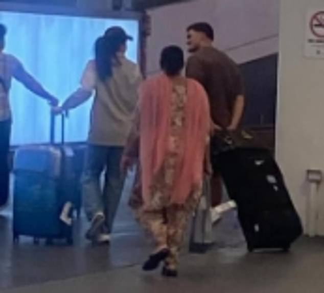 She was greeted by Cleary when she flew to Sydney on December 19, with the NRL star welcoming her with a kiss and helping her with her bags (pictured)