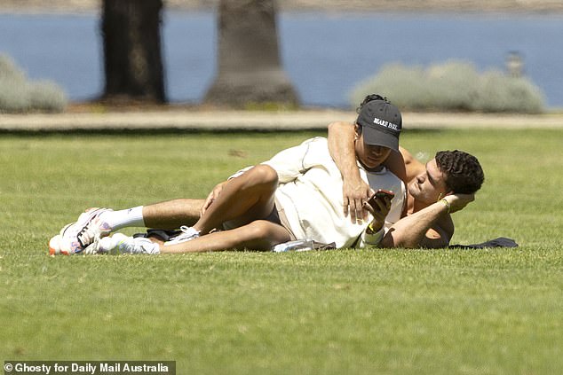 Australia's most popular sports couple was spotted cuddling in a Perth park in late October in Daily Mail Australia's exclusive photos (pictured)