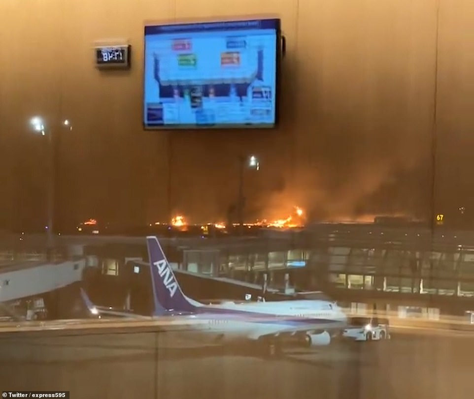 A photo taken inside the airport terminal shows the fire outside on the runway