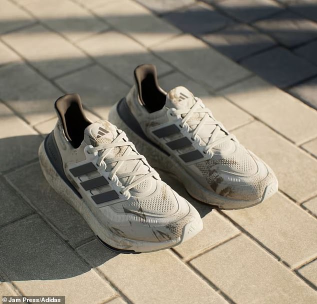 The white sneakers have gray scuffs on the side of the soles and brown spots on the front that look like mud