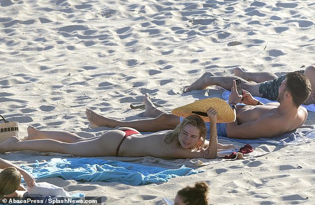 The stunner went bare on the beach day as her blonde locks dried in the sun