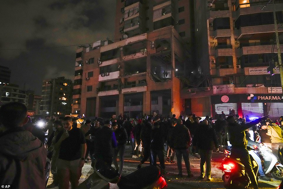 People search for survivors after a massive explosion in the southern suburbs of Beirut, Lebanon