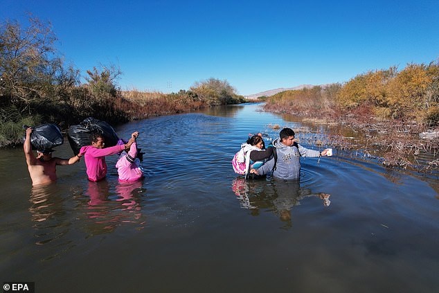 Migrants cross the Rio Bravo on their way to the US fence in Ciudad Juarez, Mexico