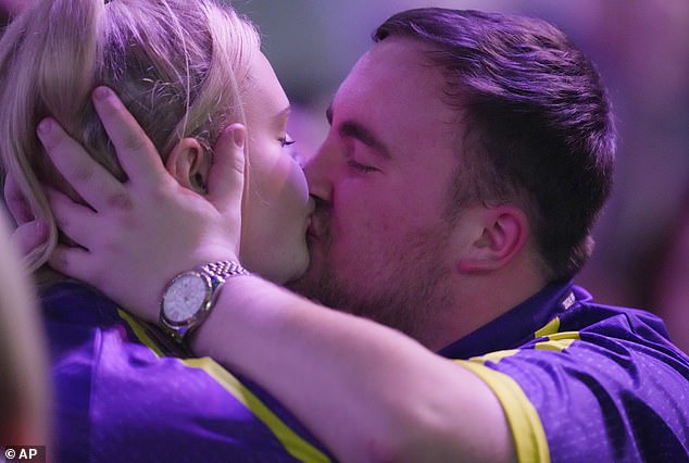 Teenage doctor sensation Luke Littler received a kiss from his girlfriend Eloise after his victory at the World Darts Championship