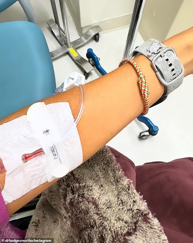 Cara shared a carousel of images, including one of her lying in a hospital bed and another showing the IV in her arm (seen)