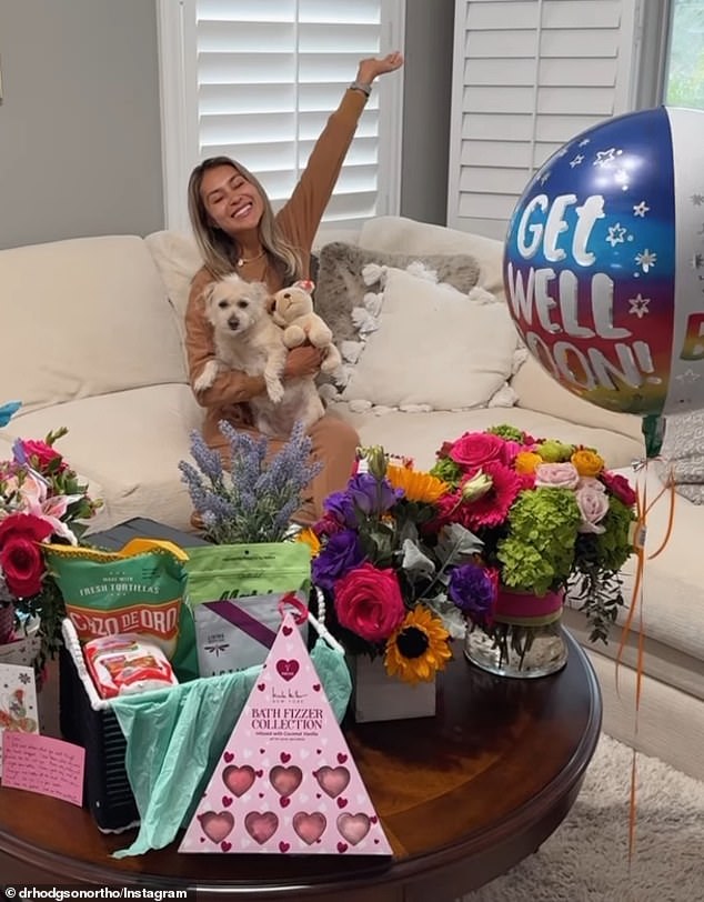 The slideshow also included several snaps of the influencer lounging on the couch at home with her dog on her lap, surrounded by an array of chocolates, flowers and balloons.