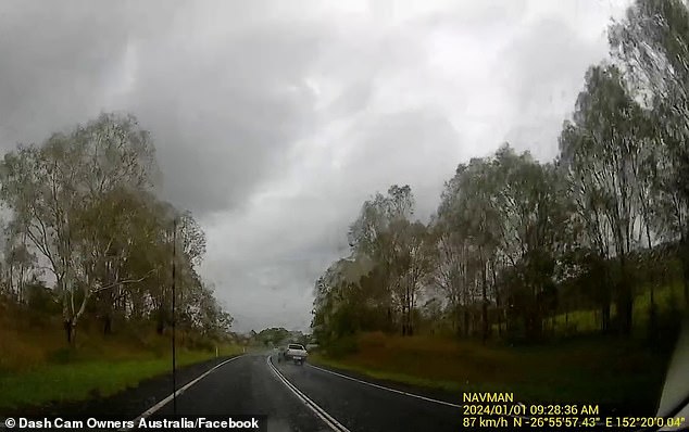 The Mitsubishi's left rear tire struck some water on the road and the vehicle swerved and turned left across both lanes onto the side embankment.