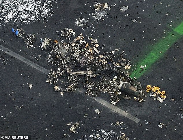 An aerial photo shows burned Japanese Coast Guard aircraft after a collision with Japan Airlines (JAL) Airbus A350 aircraft at Haneda International Airport in Tokyo