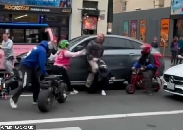 As he struggled with one rider, he was swarmed by others who attacked him as the actor was pinned against his car.