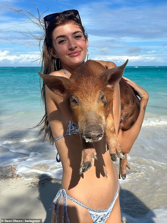 While exploring the Bahamas, Sami also spent time with some of Rose Island's famous swimming pigs, even cradling one in her arms