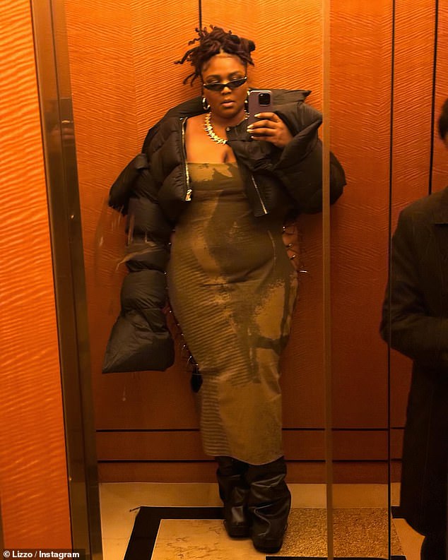 Lizzo completed her outfit with a trendy black puffer jacket and wide black leather boots