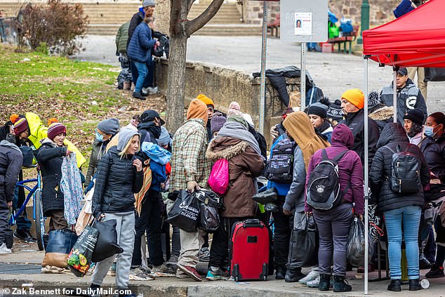 A pastor talks to drug users in McPherson Square Park off Kensington Avenue