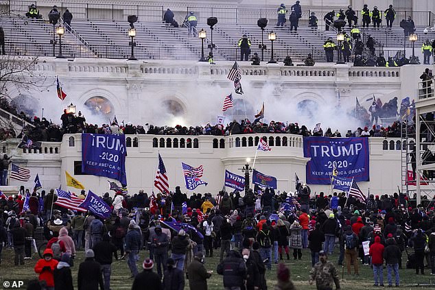 Trump and two other rioters were charged with wrongful death, conspiracy to violate civil rights, two counts of negligence under a D.C. anti-riot law, and a claim under the D.C. Survival Act.  The photo shows rioters storming the capital on January 6, 2021