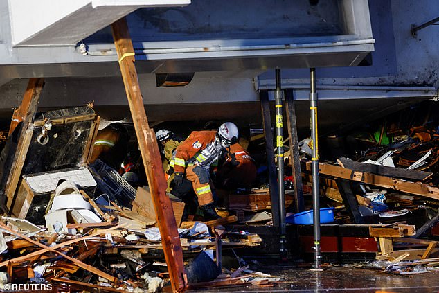 Rescue workers conduct a rescue operation at a collapsed building after an earthquake in Wajima, Ishikawa Prefecture, Japan, January 3